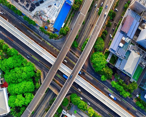 A sweeping scenic shot of the green urban skyline and infrastructure in South Jakarta