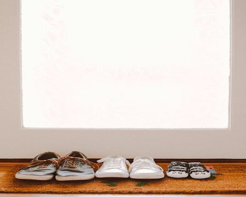 Comfortable daily walking shoes placed by the entrance door, signifying active lifestyle choices